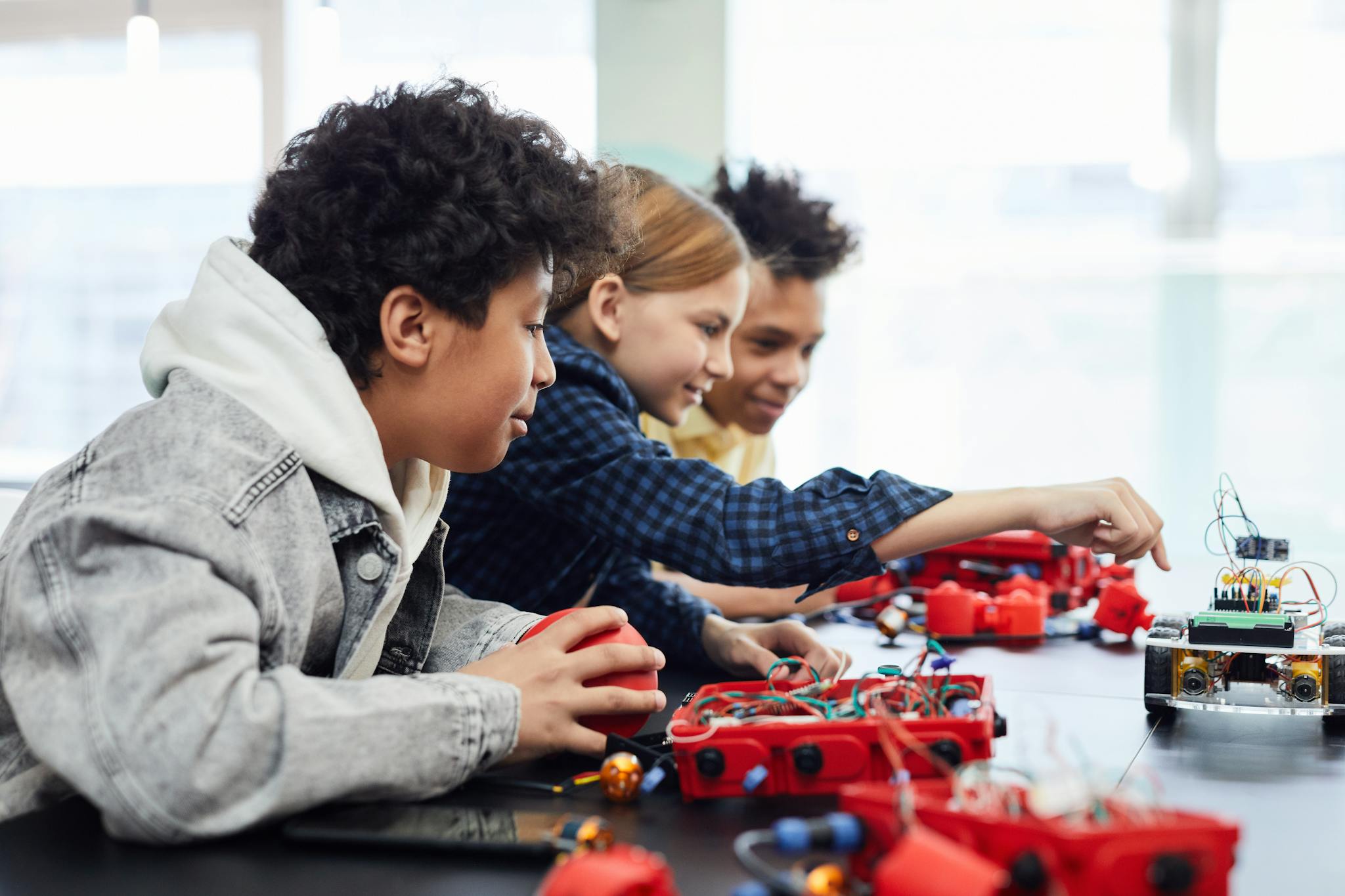 Children working on a robotics project in a classroom setting, exploring technology and creativity.