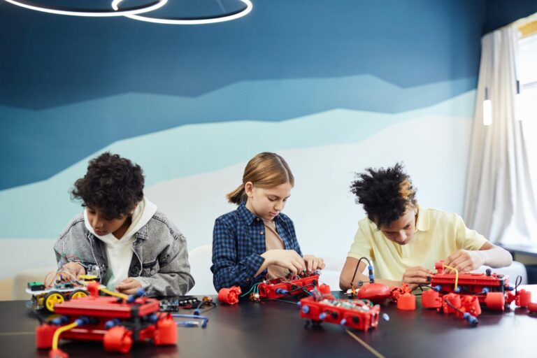 Children working on robotics projects in a classroom setting, learning and engaging.